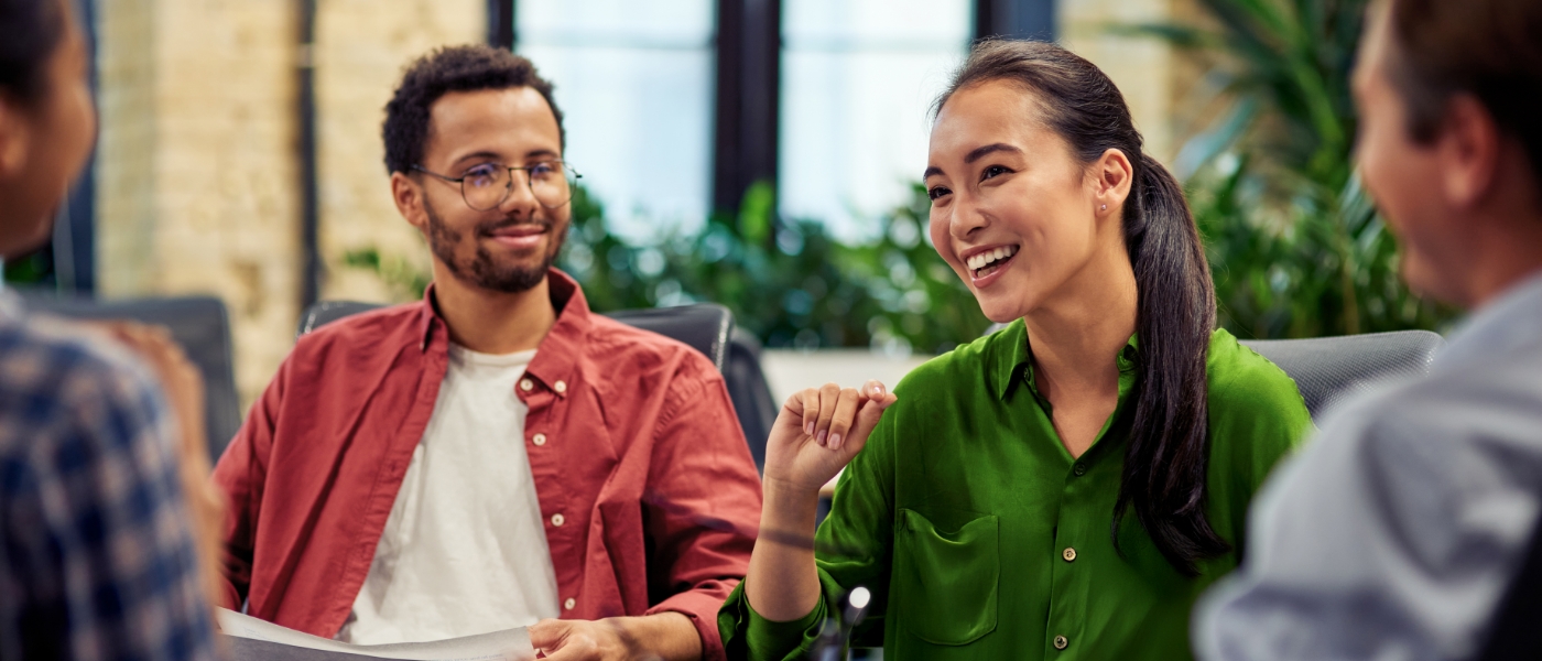 Diverse group of people at a meeting looking happy